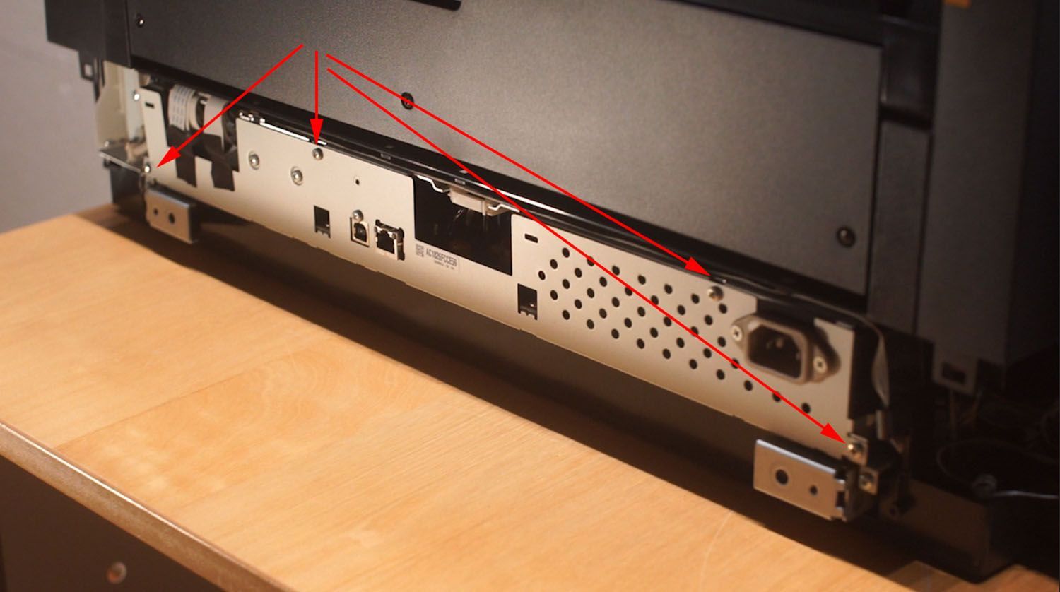 Photograph of the Back of the P800 Printer showing where to unscrew after first cover is off.